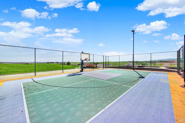 view of basketball court with fence and community basketball court