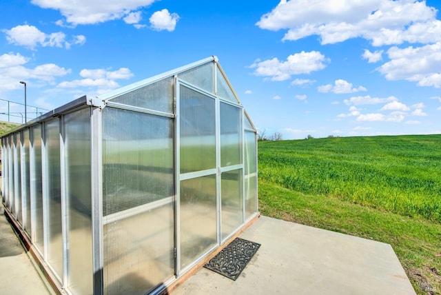 8560 Holmes Ln, Winters, CA 95694 - view of side of home featuring a greenhouse, an outbuilding, and a rural view