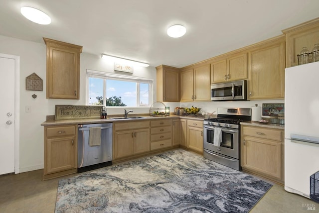 kitchen with a sink, light brown cabinets, and stainless steel appliances