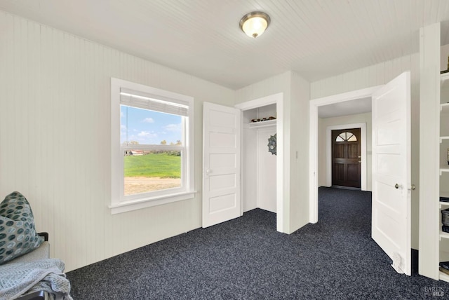 interior space featuring dark carpet