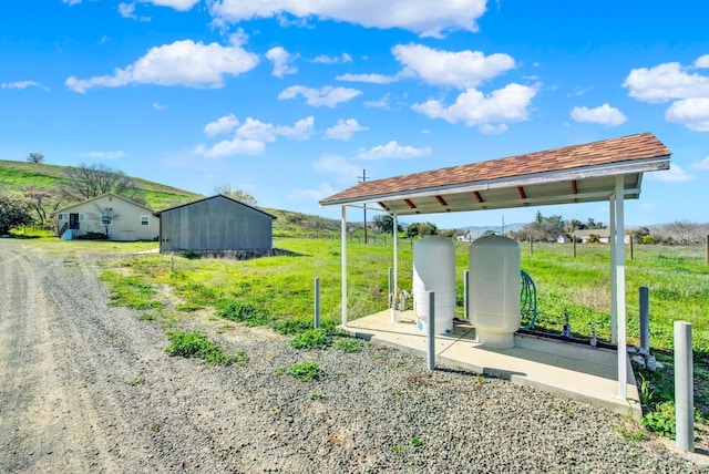 view of yard with a rural view