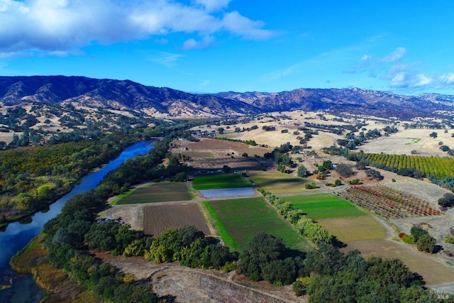 drone / aerial view featuring a rural view and a water and mountain view