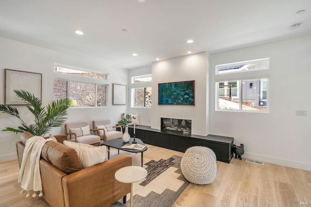living area featuring recessed lighting, visible vents, and light wood-style flooring