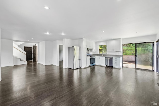 unfurnished living room with recessed lighting and dark wood-type flooring