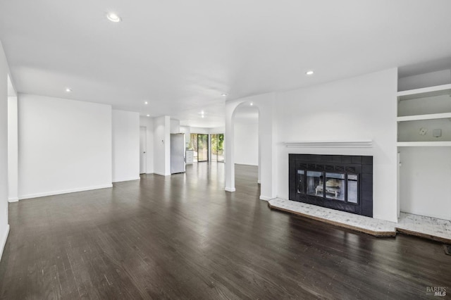 unfurnished living room featuring a fireplace, recessed lighting, and wood finished floors