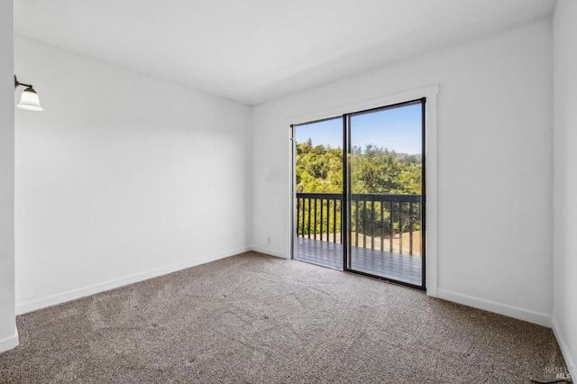 unfurnished room featuring baseboards and carpet flooring