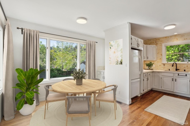 dining room featuring light wood-type flooring, baseboards, and visible vents