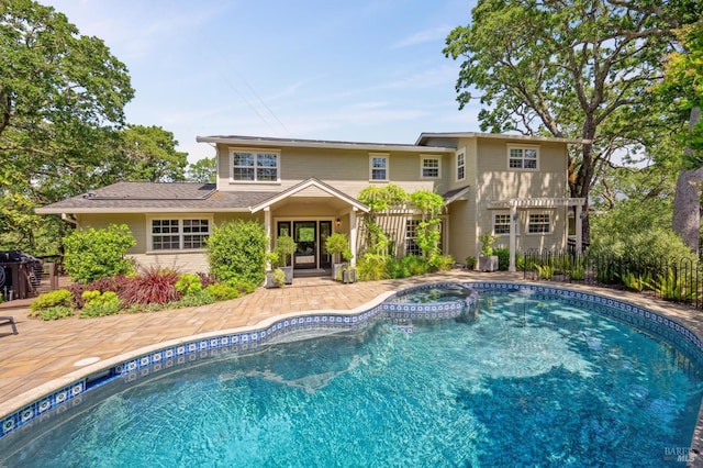view of pool featuring a patio and a pool with connected hot tub
