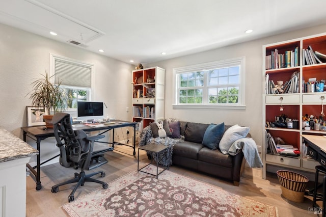 home office with visible vents, attic access, light wood-style floors, and recessed lighting