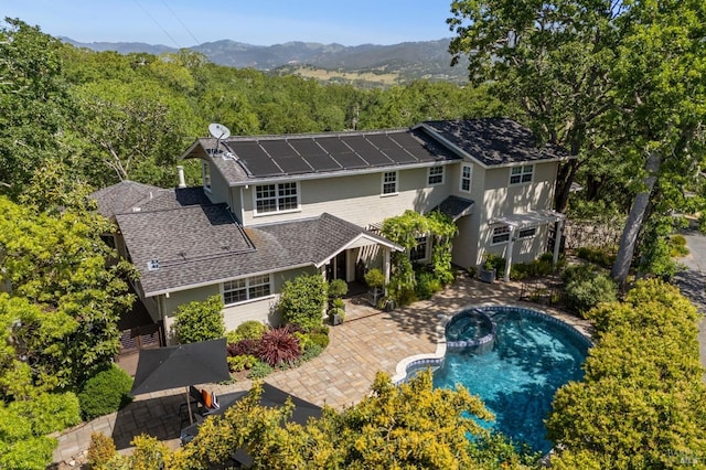 birds eye view of property with a forest view and a mountain view