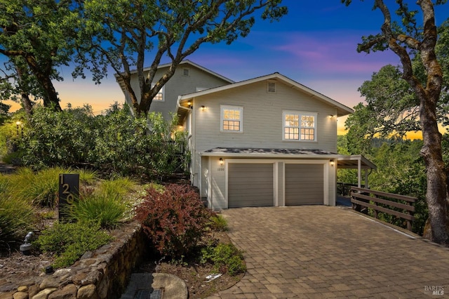 traditional-style house with a garage and decorative driveway