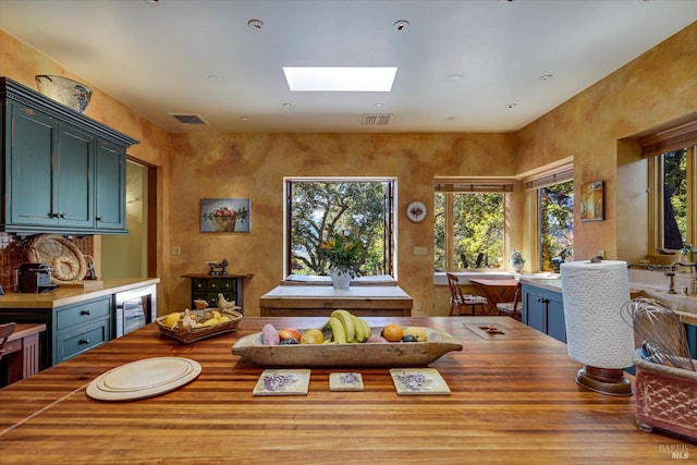 dining space featuring beverage cooler, a skylight, and visible vents
