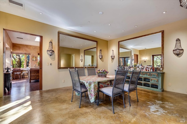 dining room featuring concrete flooring, visible vents, plenty of natural light, and recessed lighting