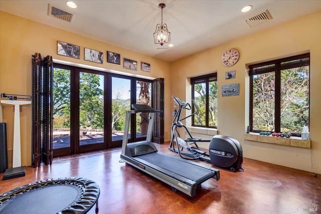 exercise room featuring an inviting chandelier, recessed lighting, and visible vents