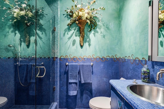 full bath featuring vanity, a shower stall, and toilet
