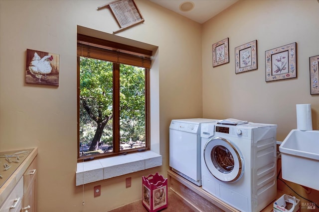 laundry area with a sink, cabinet space, and independent washer and dryer