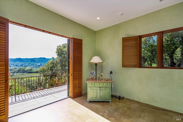 interior space featuring a mountain view and finished concrete flooring