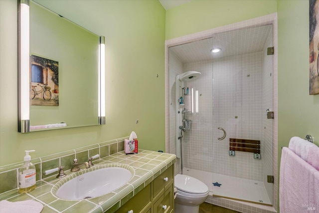 full bathroom with vanity, a stall shower, and toilet