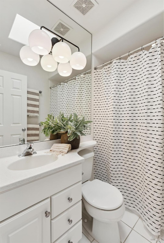bathroom with vanity, tile patterned floors, toilet, and visible vents