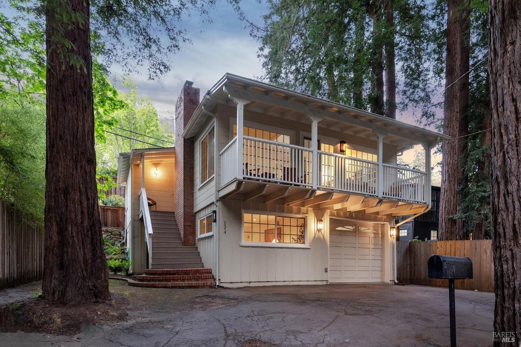 124 W Blithedale Ave, Mill Valley, CA 94941 - view of front of home with a chimney, stairway, fence, a balcony, and an attached garage
