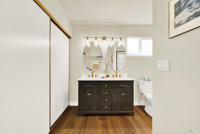 1426 Shelby Dr, Fairfield, CA 94534 - bathroom featuring wood finished floors, double vanity, toilet, and baseboards