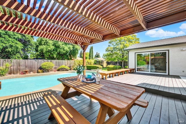 view of swimming pool featuring a wooden deck, a pergola, a fenced in pool, and a fenced backyard