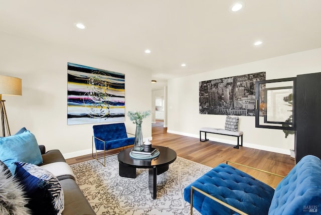 living area with wood finished floors, baseboards, and recessed lighting