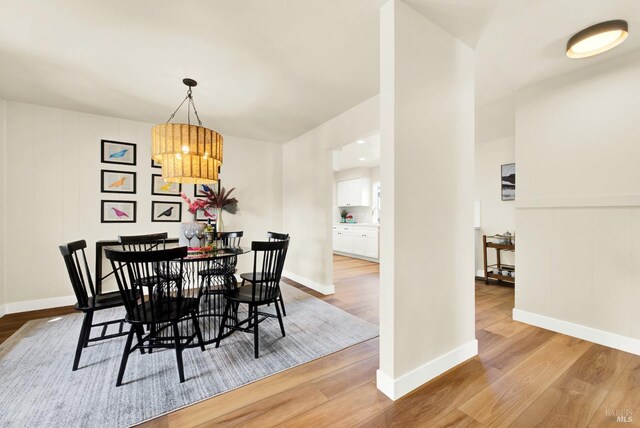 bathroom featuring toilet, a shower, wood finished floors, visible vents, and baseboards