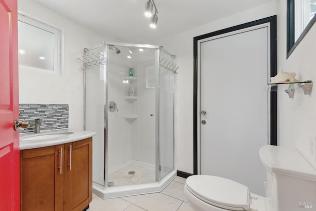 full bath featuring vanity, toilet, tasteful backsplash, and a stall shower