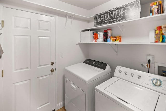 clothes washing area featuring laundry area and washer and clothes dryer