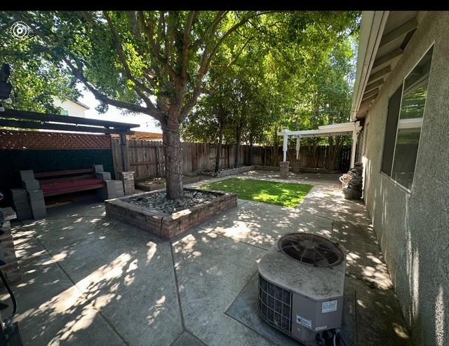 view of patio / terrace featuring a pergola, cooling unit, and a fenced backyard