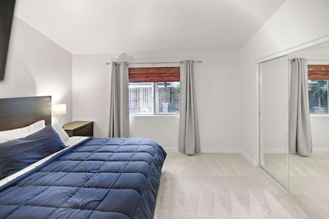 carpeted bedroom with baseboards and multiple windows