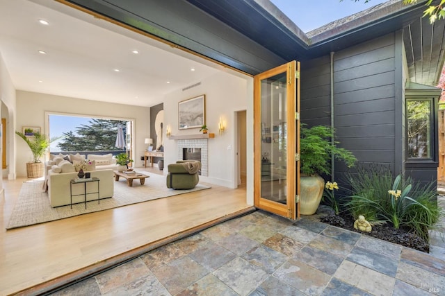 entrance to property with visible vents, a patio, stucco siding, and outdoor lounge area