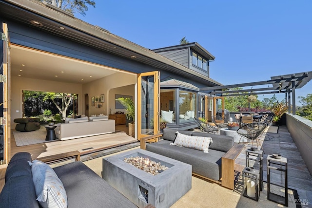 view of patio / terrace featuring an outdoor living space with a fire pit, a pergola, and outdoor dining area