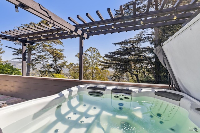 wooden deck featuring a pergola and a hot tub