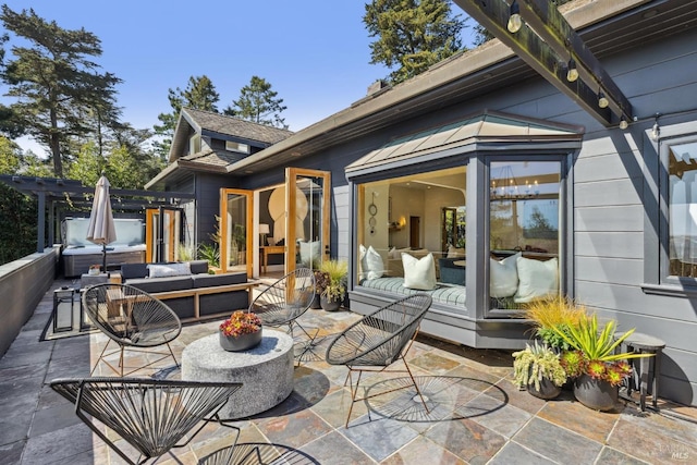 rear view of property featuring a patio and an outdoor living space