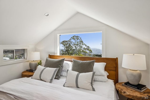 bedroom with a mountain view and lofted ceiling