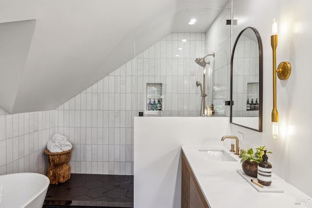 bathroom with vanity, tile walls, recessed lighting, a walk in shower, and a freestanding bath