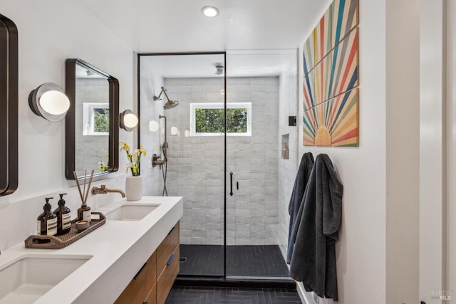 bathroom featuring double vanity, a sink, recessed lighting, and a shower stall
