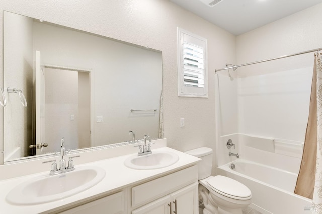 full bath featuring a sink, double vanity, toilet, and shower / tub combo