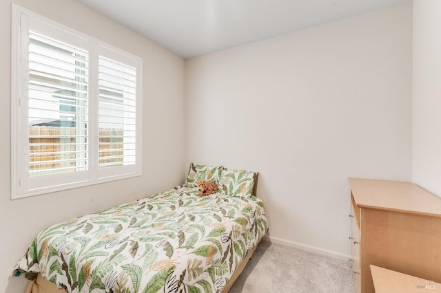 carpeted bedroom featuring baseboards