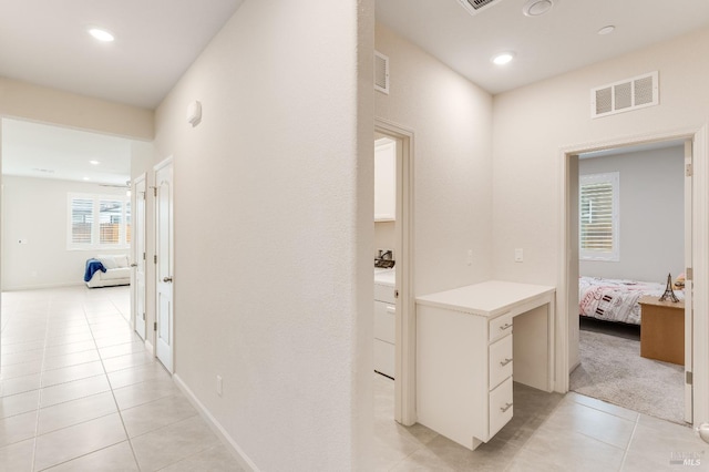 corridor featuring light tile patterned floors, visible vents, and recessed lighting