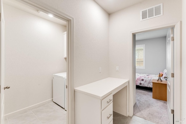 clothes washing area featuring baseboards, light tile patterned floors, and visible vents