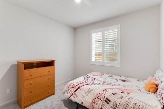 carpeted bedroom with baseboards