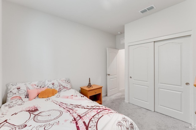 bedroom featuring light colored carpet, a closet, and visible vents