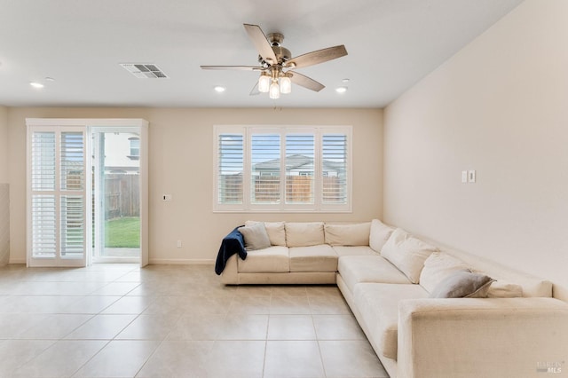 living room featuring a ceiling fan, visible vents, baseboards, light tile patterned flooring, and recessed lighting