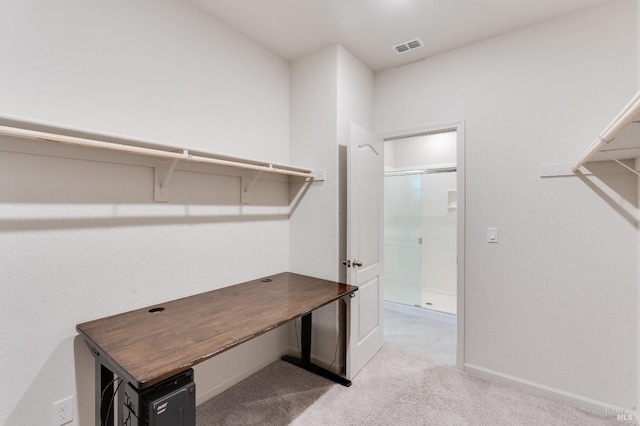 walk in closet with light colored carpet and visible vents