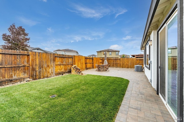 view of yard featuring a fenced backyard, a patio area, and cooling unit
