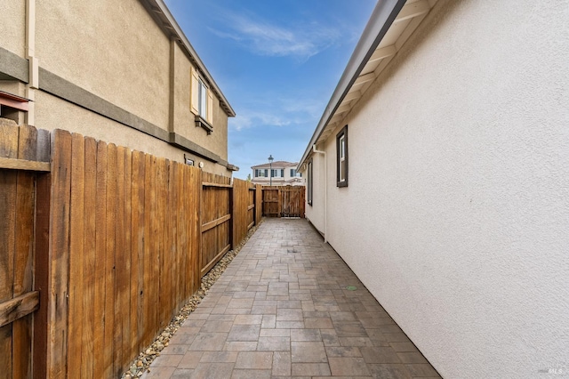 view of home's exterior with fence and stucco siding