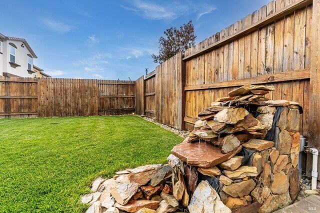view of yard with a fenced backyard